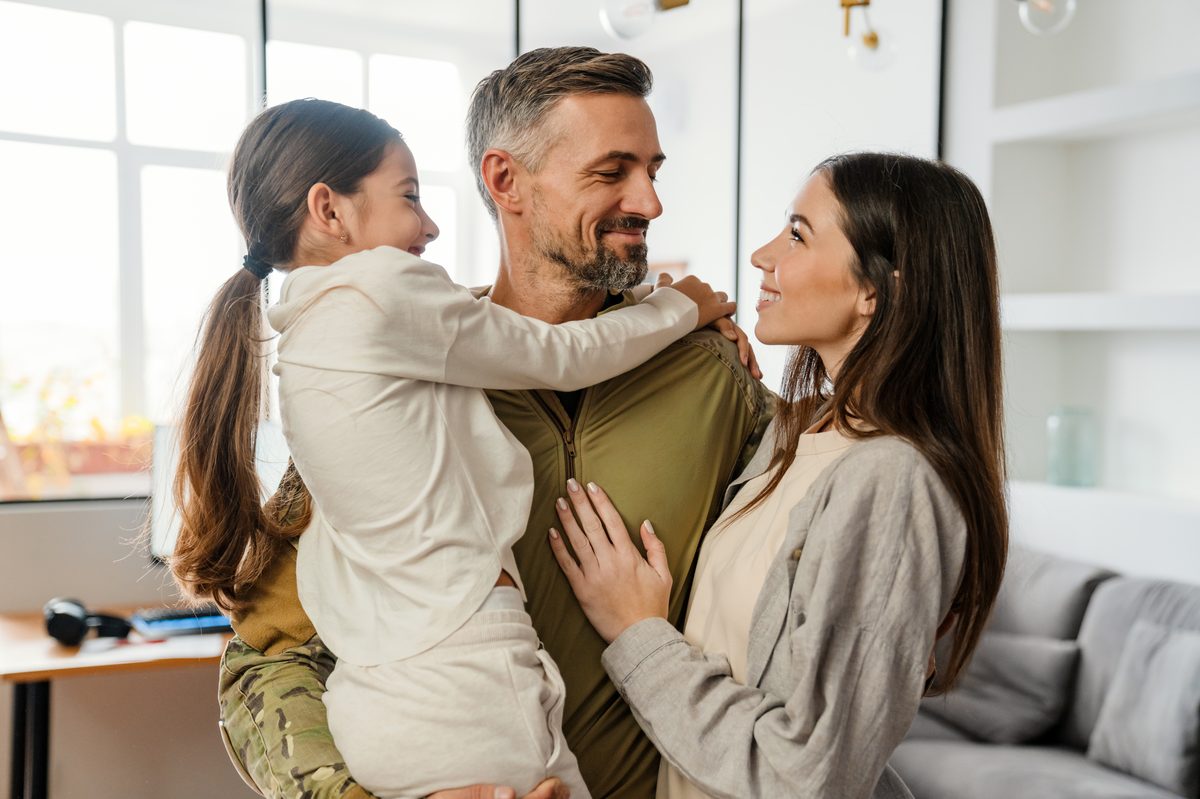 Young family smiling together in their bright home
